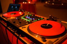 a turntable sitting on top of a table next to a laptop and dj's mixer