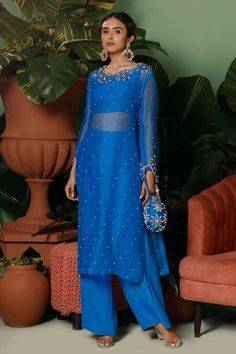 Cobalt blue kurta with sequin, pearl, cutdana, stone embellished in floral pattern. Paired with bustier and pant.
Components: 3
Pattern: Embellished
Type Of Work: Sequin, pearl, cutdana, stone
Neckline: Boat neck
Sleeve Type: Full sleeves
Fabric: Kurta: Organza, Pant: Crepe, Bustier: Shantoon
Color: Blue
Other Details: 
Length:
Kurta: 46 inches
Note: Potli shown in the image is not for sale
Occasion: Sangeet - Aza Fashions Brocade Pants With Kurti, Full Sleeve Kurti Designs, Boat Neck Kurti, Bali Outfits, Mahima Mahajan, Suits For Women Indian, Brocade Lehenga, Yellow Kurta, Trendy Outfits Indian