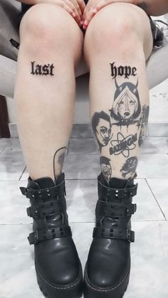 two people with tattoos on their legs sitting next to each other and one is wearing black boots