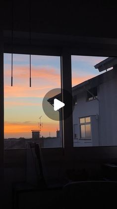 the sun is setting in front of some windows