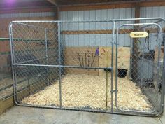 a caged in area filled with lots of hay and other things to feed the animals