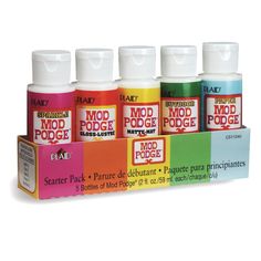 four different colors of mod podge paint in a display case