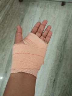 a hand with a bandage on it is in the middle of a flooring area