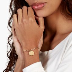 Treat yourself or someone special to our eternally best-selling Callie bracelet. Its chic chain link style is finished with an engravable disc pendant for the perfect everyday look. Available in 14k gold plated brass Pendant measures 5/8" 6" elongated link chain with 1" extender Lobster claw closure Made in the USA With engraving this item is FINAL SALE SKU: BYB1105 Adjustable Chain Name Bracelet For Friendship, Modern Jewelry With Adjustable Chain For Friendship, Gold Chain Charm Bracelet With Rectangular Links, Elegant Name Bracelet With Charms For Friendship, Gold-tone Chain Charm Bracelet, Brass Chain Link Bracelet, Metal Oval Link Charm Bracelet, Elegant Personalized Link Jewelry, Tarnish Resistant Metal Paperclip Bracelet