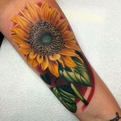 a sunflower tattoo on the arm