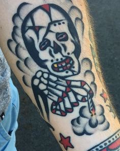 a man's arm with a tattoo on it that has a skeleton and stars