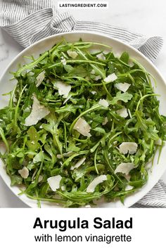 arugula salad with lemon vinaigrete and parmesan cheese on top