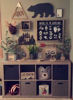 a room with various items and decorations on the wall, including bookshelves and bins