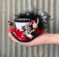 "Often copied, never duplicated. This is a Chiki Bird Original Design. Don't be fooled by knock-offs. THIS IS A MICRO MINI TOP HAT...It fits in the palm of your had! `The Queen of Hearts, she made some tarts, All on a summer day: The Knave of Hearts, he stole those tarts, And took them quite away!' The Accusation! That sweet little White Rabbit heralds the accusation to the jury! What say you? I say innocent. Who would want the Queen's tarts anyway? I bet they are all sour and yucky! This hat fe Mad Hatter Alice In Wonderland, Hatter Alice In Wonderland, Mad Hatter Hat, Mini Hat, Mini Top Hat, Tea Party Hats, Mad Tea Party, Top Hats, Mini Top