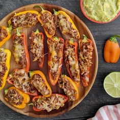 several stuffed peppers on a wooden platter