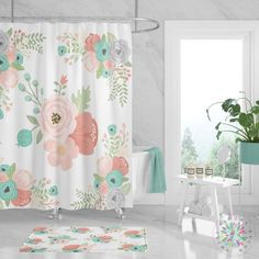 a bathroom with a shower curtain, rug and potted plant