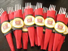 a bunch of red and yellow forks with crowns on them sitting next to each other