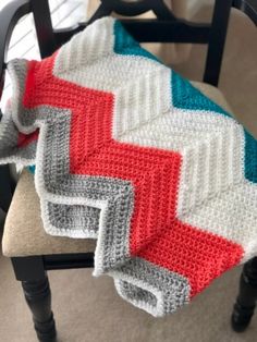 a crocheted blanket sitting on top of a chair