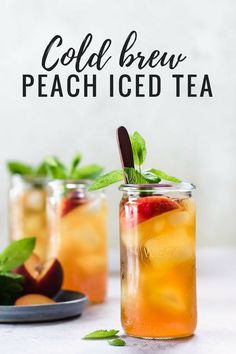 two mason jars filled with iced tea and sliced peaches on a marble table top