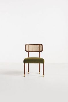 a green chair sitting on top of a white floor