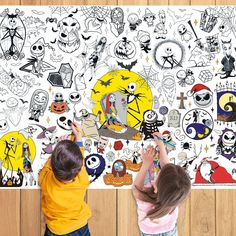 two children standing in front of a wall with halloween stickers on it and one child reaching up