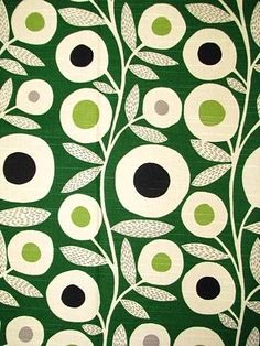 a green and white wallpaper with black dots on it's center flower design