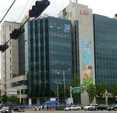 an intersection with traffic lights, cars and tall buildings