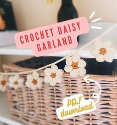 there is a basket with crochet daisy garland on it