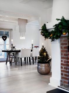 a living room filled with furniture and a fire place next to a fireplace covered in christmas decorations