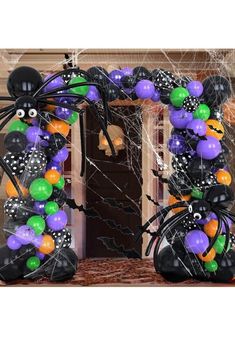 a halloween decoration with balloons and spider webs