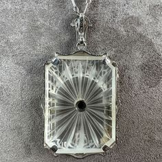 Measuring approx. 1 1/2 x 13/16 inches, centering a Swiss cut diamond weighing approx. 0.02ct., on a carved rock crystal within a filigree frame. Fashioned in 10k white gold. Stamped "EMESCO" "10K". On a chain with alternating long and short links fashioned in 10k white gold. Rock Crystal Necklace, Filigree Frame, Rock Crystal, Vintage Diamond, Crystal Necklace, Diamond Cuts, White Gold, Carving, Chain