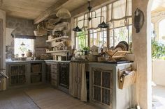 an old fashioned kitchen with lots of pots and pans