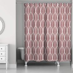 a bathroom with a shower curtain, mirror and white dresser in front of the tub