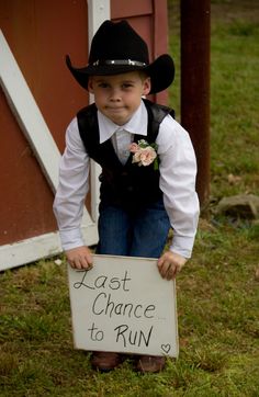 a young boy dressed in cowboy attire holding a sign that says lost chance to run