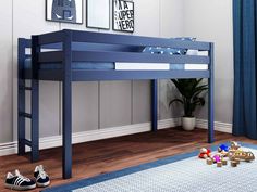 a blue bunk bed sitting on top of a wooden floor next to a potted plant