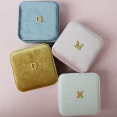 three personalized jewelry cases sitting on top of each other, one with the letter d