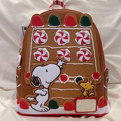 Reposhing This Item I Purchased From @Luv_crystal. Never Used After I Bought It! Super Cute Though! Just Cleaning Out My Closet So Delectably Fun! It's Peppermint Scented Too! Loungefly Peanuts Snoopy Gingerbread House Mini Backpack. Snoopy And Woodstock Place Peppermints And Other Red And Green Candies Onto A Gingerbread House, Decked Out With White Icing Trim. Gumdrops And Red And Green Candies, Along With Icing, Continue On The Side Pocket. Sleeping Snoopy In A Wreath On The Back Too!. Candy Snoopy Gingerbread House, Gingerbread House Mini, Toy Story Soldiers, Pastel Backpack, Mini Gingerbread House, Loungefly Hello Kitty, Minnie Mouse Backpack, Peppermint Scent, Disney Up