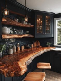 a wooden counter top in a kitchen next to a window with lots of lights on it