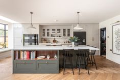 a large kitchen with an island in the middle and lots of counter space on one side