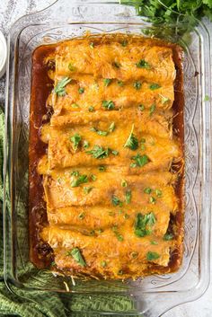 an enchilada dish in a glass casserole dish on a table