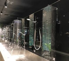 a row of shower heads in a bathroom