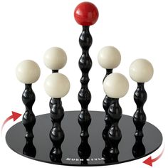 an image of a black and white object with red ball on it's top