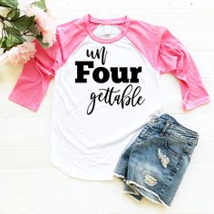 a white and pink shirt with the words un four gettable on it next to denim shorts