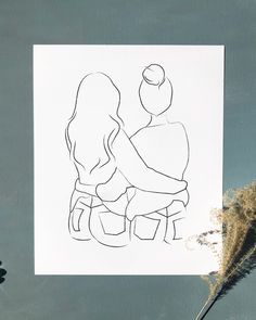 a drawing of two people sitting next to each other on top of a piece of paper