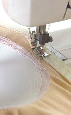 the sewing machine is working on the fabric that has been stitched together with it's needle