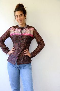 Lovely vintage 70s floral blouse in black with floral print in pink red yellow and green, buttons down, neck tie, polyester, somewhat sheer, original tag intact, aside from minor signs of wear, good vintage condition, clean, ready to wear.** Model is 5'8" and size S for reference  Tag size: 44Approximate size: S/M - please refer to the measurementsM E A S U R E M E N T S -were taken with garments laying flat, please double where necessary.————————————♥————Bust: 18.5"- 47 cmShoulder to Shoulder: Retro Floral Print Blouse For Fall, Vintage Multicolor Tops For Daywear, Retro Patterned Blouse For Spring, Retro Patterned Spring Blouse, Fitted Floral Print Blouse With Tie Neck, Spring Retro Tie Neck Tops, Spring Retro Tie-neck Tops, Retro Tie Neck Tops For Spring, Retro Floral Print Blouse For Daywear