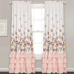 the curtains in this room are decorated with pink and white flowers, butterflies, and ruffles