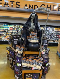 a skeleton sitting on top of a chair in a store filled with halloween treats and snacks