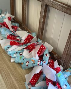 several pieces of fabric sitting on top of a wooden floor next to a window sill