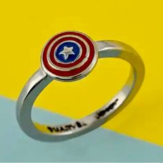 the captain's shield ring is shown on a yellow and blue background