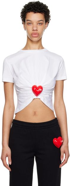 Moschino: White Inflatable Heart T-Shirt | SSENSE Casual Cotton Tops With Appliqué Logo, White Short Sleeve Tops With Appliqué Logo, Cotton Graphic Tee With Appliqué Logo, Sporty Short Sleeve Top With Appliqué Logo, Casual Crew Neck T-shirt With Heart Patch, Spring Crew Neck Top With Heart Patch, Spring Heart Patch Crew Neck Top, Fitted Crew Neck Top With Heart Graphic, White Cotton Top With Heart Patch