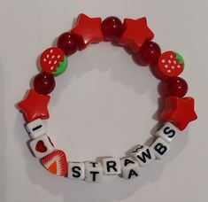 a red bracelet with white letters and fruits on it that says i love strawberries