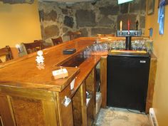 an empty bar with wine glasses on the counter