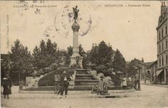 an old black and white photo of people in front of a fountain with a statue on top