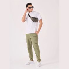 "Get ready to rock the streets with our Olive Green Straight Leg Cargo Jogger. These pants are the perfect fusion of style and practicality, designed for those who want to make a statement while staying comfortable. Step into the urban jungle with confidence, as these joggers are designed with care from premium fabric.It's time to make a statement, and we've got the perfect pants for you. Product Features: Olive green twill fabric Cargo style Elasticated ankle cord Button fastening Multi pockets Silver hardware trims Stretch added for extra comfort Our Model is 6'1\" and Wears Size Medium. To find the perfect fit for yourself check our Size Guide. FIND YOUR SIZE and check our size guide to find your perfect fit. Size = 30-40 Waist = 70cm - 95cm Hip = 92cm - 117cm Inseam = 72cm Waist is mea Urban Style Sweatpants With Hip Pockets For Outdoor, Urban Sweatpants With Hip Pockets For Outdoor, Urban Parachute Pants With Hip Pockets, Casual Straight Leg Bottoms For Urban Adventures, Urban Joggers With Hip Pockets For Outdoor, Urban Sweatpants With Multiple Pockets, Urban Streetwear Pants With Hip Pockets, Urban Pants With Hip Pockets For Streetwear, Urban Sweatpants With Pockets